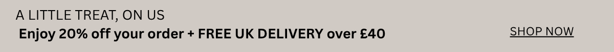 A promotional banner with a light gray background featuring black text that reads 'A LITTLE TREAT, ON US', 'Enjoy 20% off your order + FREE UK DELIVERY over £40', and a 'SHOP NOW' link on the right.